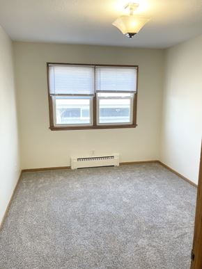 Fridley apartment for rent - A room with a window and a heater on the floor.