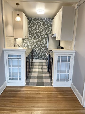 St. Paul apartment for rent - A kitchen with white cabinets and a checkered floor.