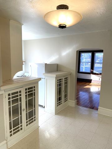 Saint Paul apartment for rent - A kitchen with a white cabinet and a window.
