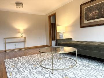 Saint Paul apartment for rent - A living room with a glass table and a grey sofa.