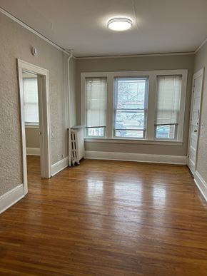 St. Paul apartment for rent - A room with wooden floors and white walls.
