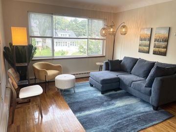 Saint Paul apartment for rent - A living room with a grey couch and a yellow chair.