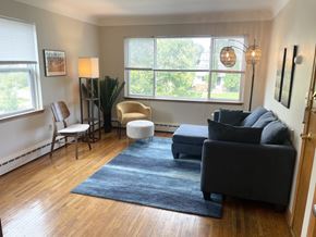 Saint Paul apartment for rent - Well-lit living room with large picture window.