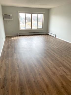 Bloomington apartment for rent - Graciously-sized, sunlit living room with large picture window.