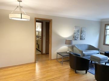 Saint Paul apartment for rent - A living room with a grey couch and a wooden floor.