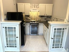 St. Paul apartment for rent - A black fridge and stove in a white kitchen.
