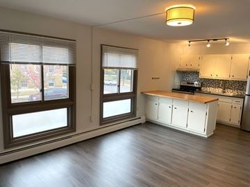 Minneapolis apartment for rent - A kitchen with white cabinets and a wooden island.