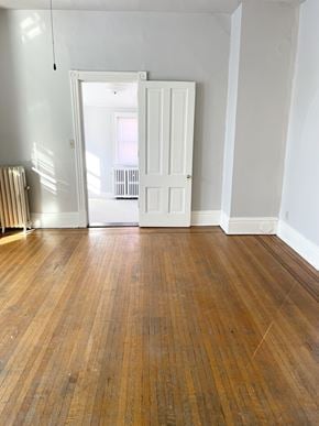 St. Paul apartment for rent - A room with a wooden floor and white walls.