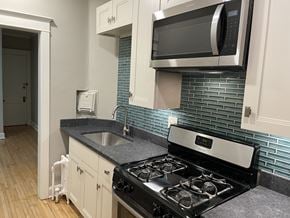 St. Paul apartment for rent - Custom kitchen cabinets, granite countertops, stainless steel appliances including microwave over stove.
