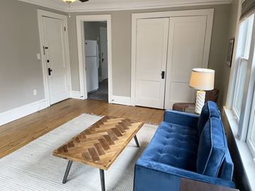 St. Paul apartment for rent - A living room with a blue couch and a wooden coffee table.