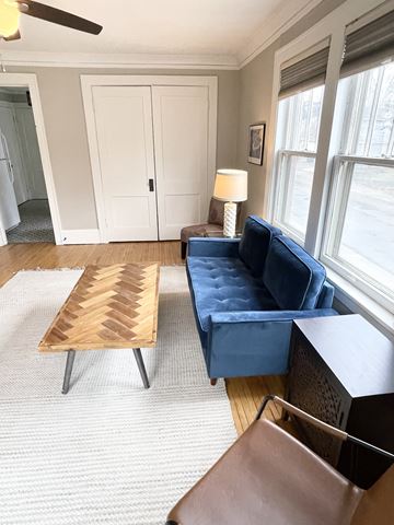 St. Paul apartment for rent - A blue couch sits in a living room with a wooden coffee table.