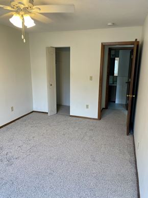 St. Paul apartment for rent - A room with a ceiling fan and carpeted floor.