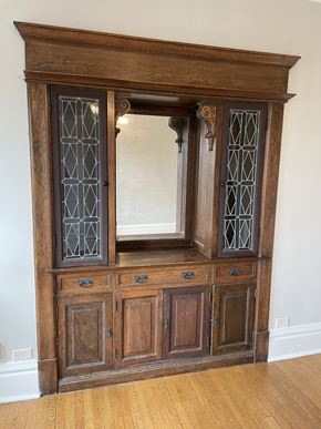 St. Paul apartment for rent - A wooden cabinet with glass doors and drawers.
