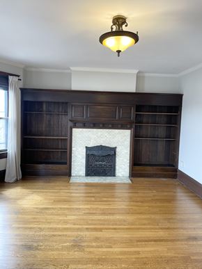 St. Paul apartment for rent - A fireplace with a white mantle and a wooden shelf above it.
