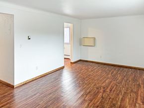 St. Paul apartment for rent - A room with wooden floors and white walls.