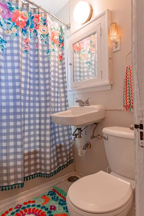 St. Paul apartment for rent - A bathroom with a toilet, sink, and shower curtain.