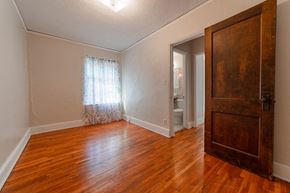 St. Paul apartment for rent - A room with a wooden floor and a door.