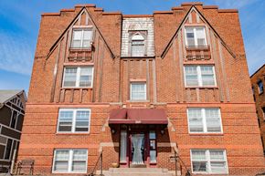 St. Paul apartment for rent - A red brick building with a balcony and a door.