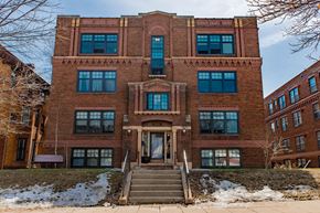 St. Paul apartment for rent - A red brick building with a staircase leading to the entrance.