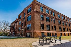 St. Paul apartment for rent - A red brick building with a table and chairs outside.