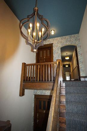 St. Paul apartment for rent - A staircase with a chandelier hanging above it.
