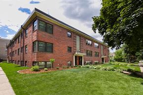 St. Paul apartment for rent - A red brick building with a green lawn in front.