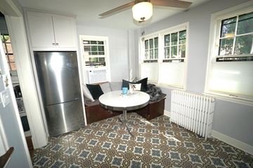 St. Paul apartment for rent - A kitchen with a refrigerator and a dining table with chairs.