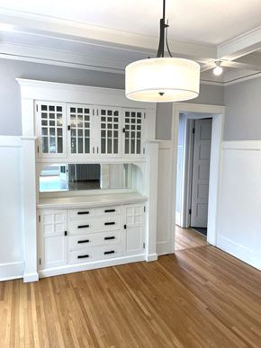 St. Paul apartment for rent - A white cabinet with a window and drawers is in a room with wooden floors.