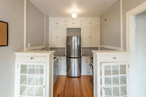 Minneapolis apartment for rent - A kitchen with white cabinets and a stainless steel refrigerator.