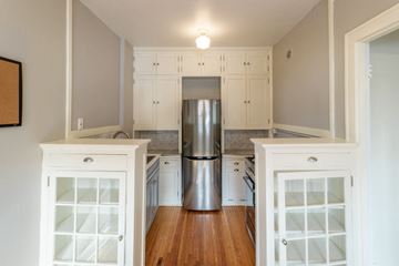 Minneapolis apartment for rent - A kitchen with white cabinets and a stainless steel refrigerator.