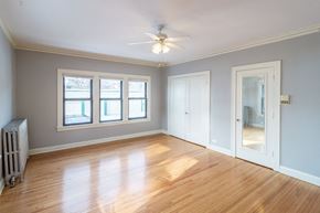 Minneapolis apartment for rent - A room with a ceiling fan and wooden floors.