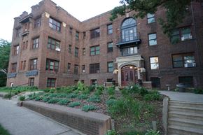 St. Paul apartment for rent - A large red brick building with a green lawn in front.