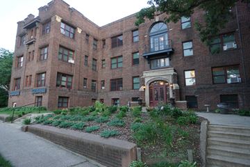 St. Paul apartment for rent - A large red brick building with a green lawn in front.