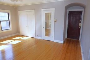 Minneapolis apartment for rent - A room with a wooden floor and three doors.