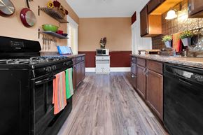 St. Paul apartment for rent - A kitchen with black appliances and wooden floors.