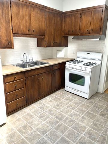 St. Paul apartment for rent - A white stove is in a kitchen with wooden cabinets.