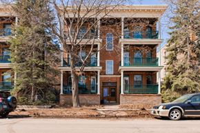 St. Paul apartment for rent - A brown building with a black car in front.