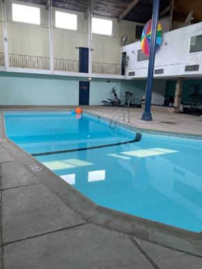 New Hope apartment for rent - A large indoor swimming pool with a blue tiled edge.