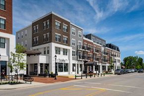 Lewis Center apartment for rent - A street view of a row of buildings with a clear blue sky above.
