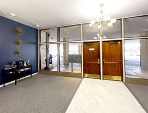 Akron apartment for rent - A room with a chandelier, a table with items on it, and a wall with star decorations.