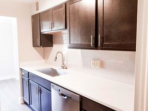 Cleveland Heights apartment for rent - A kitchen with dark brown cabinets and a white counter.