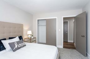 Cleveland Heights apartment for rent - A bedroom with a bed, nightstand, and two doors.