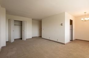 Cleveland Heights apartment for rent - A spacious room with a carpeted floor and a chandelier hanging from the ceiling.