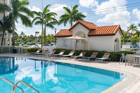 Doral apartment for rent - A pool with a small building behind it.