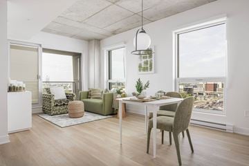 Montreal apartment for rent - A modern living room with a dining table and chairs.