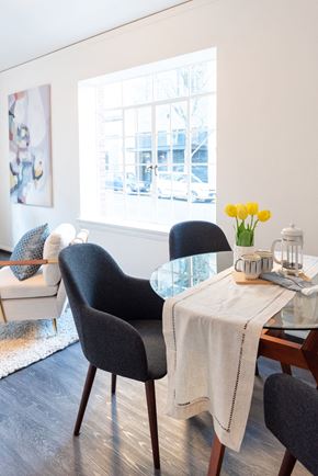 Portland apartment for rent - dining nook with living room and large picture window behind