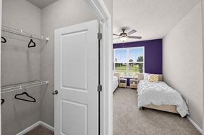 Lake Charles apartment for rent - A bedroom with a white bed and a purple accent wall.