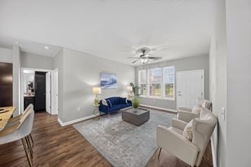 Lake Charles apartment for rent - A living room with a blue sofa and a grey rug.