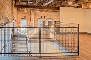 Evansville apartment for rent - A room with a brick wall and a metal railing.