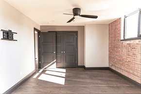 Evansville apartment for rent - A room with a ceiling fan and a large door.